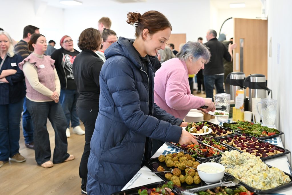 Morag from FEL Scotland standing at the lunch table, choosing from a buffet 